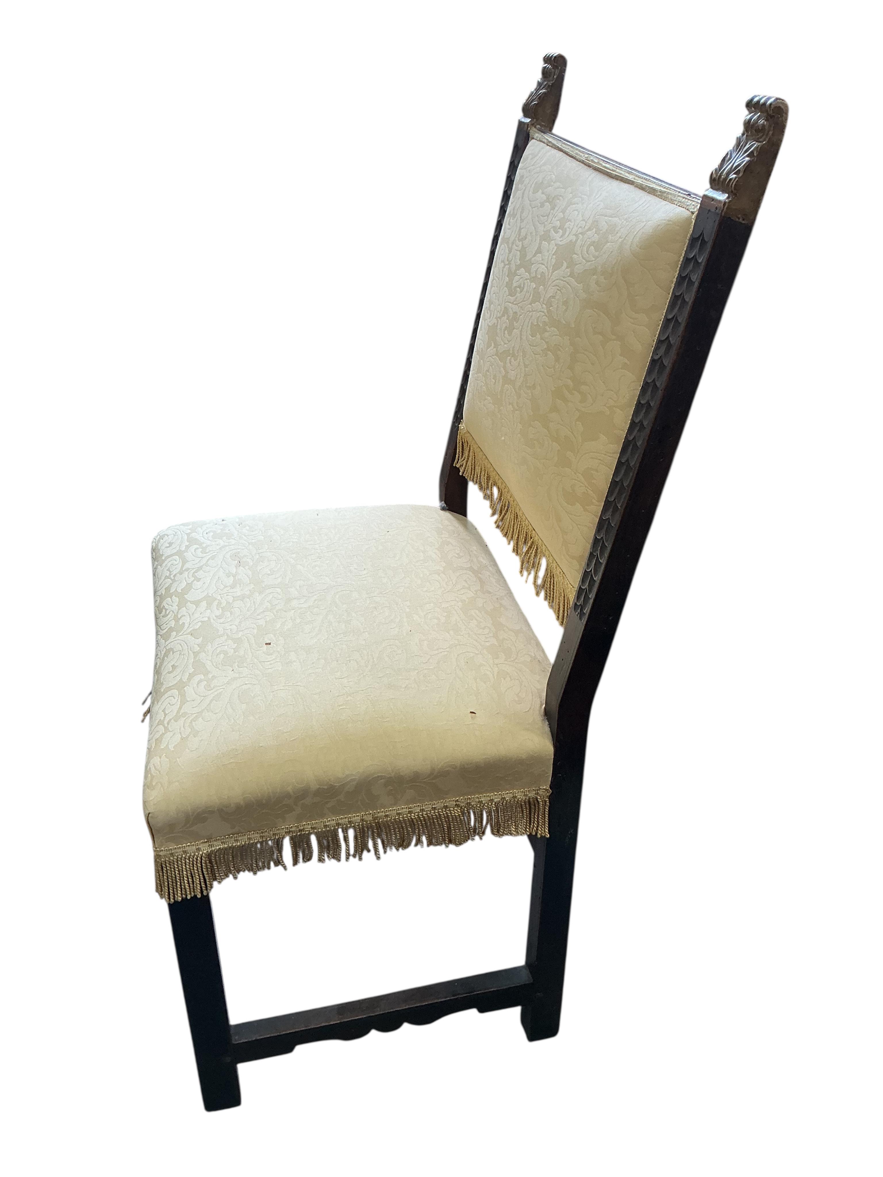 A pair of Italian side chairs carved with foliate bands, parcel gilt terminals and fretwork stretcher, upholstered in yellow damask, width 58cm, depth 48cm, height 118cm